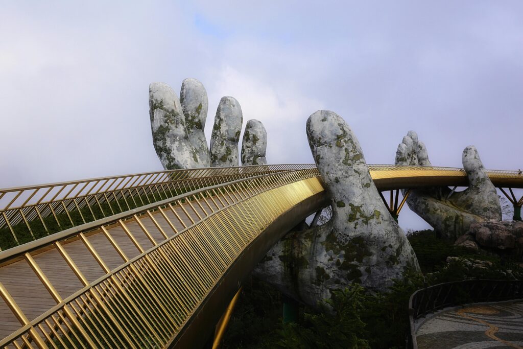 Golden Bridge in Vietnam with giant hands architecture in early morning light.